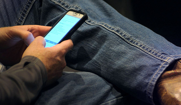 Social Media phone Man on phone looking at social media